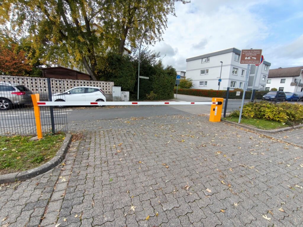 Geschlossene Schranke vor einer gepflasterten Einfahrt zu einer Feuerwache